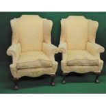 Pair of wing back upholstered armchairs having scrolled arms and removable seat cushions,