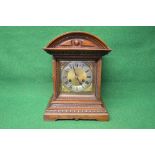 Oak cased 8 day mantle clock having brass and silvered dial with black Roman Numerals and black