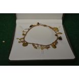9ct gold charm bracelet having twenty one gold and one other charm (gross weight 38.