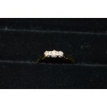 18ct gold ladies ring set with a row of three small diamonds (gross weight 2.