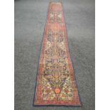 Red and blue ground carpet runner having cream, blue,