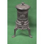 Small circular iron wood burning stove standing on three legs - 22.