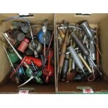 Two boxes of assorted oil cans and greasers as well as oil and grease guns