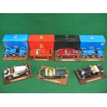 Seven large scale metal and plastic Burago model sports cars mounted on display plinths,