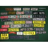Large quantity of various design British and foreign vehicle number plates for display purposes