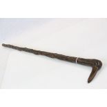 Rustic walking stick with stylized bird head handle