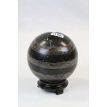 Striped Hardstone Sphere on a small varnished wooden stand, sphere approx 10cm diameter