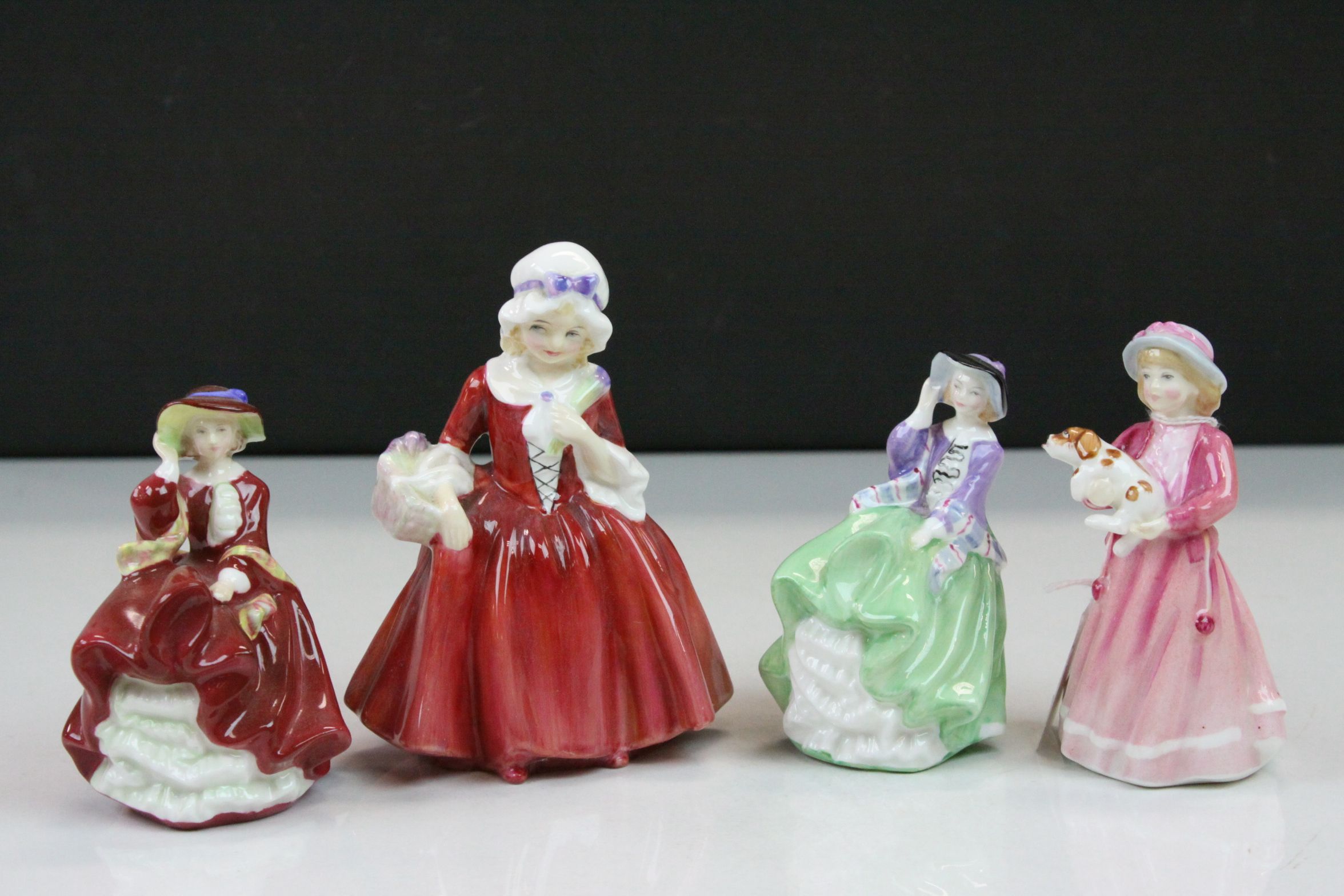 Four Royal Doulton ceramic figurines to include; Lavinia HN1955, Top O' the Hill HN3499, My First