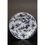 Tin glaze shallow bowl with hand painted Oriental design, approx 33cm diameter