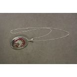 Silver photo locket with embossed horse shoe set with rubies