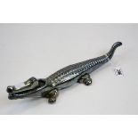 Novelty nut cracker in the form of an iron lustre crocodile