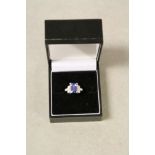 Tanzanite and diamond 18ct white gold ring, the central rectangular step cut tanzanite measuring