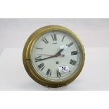 Bulkhead type Brass key wind Clock with bevelled glass dial cover, red seconds hand and marked "Made