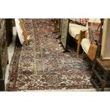 Heriz type carpet, blue ground with medallions, within an ivory floral border, approx. 370cm in