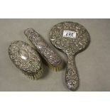 Hallmarked Silver three piece Hand Mirror & Brush set with heavily embossed design