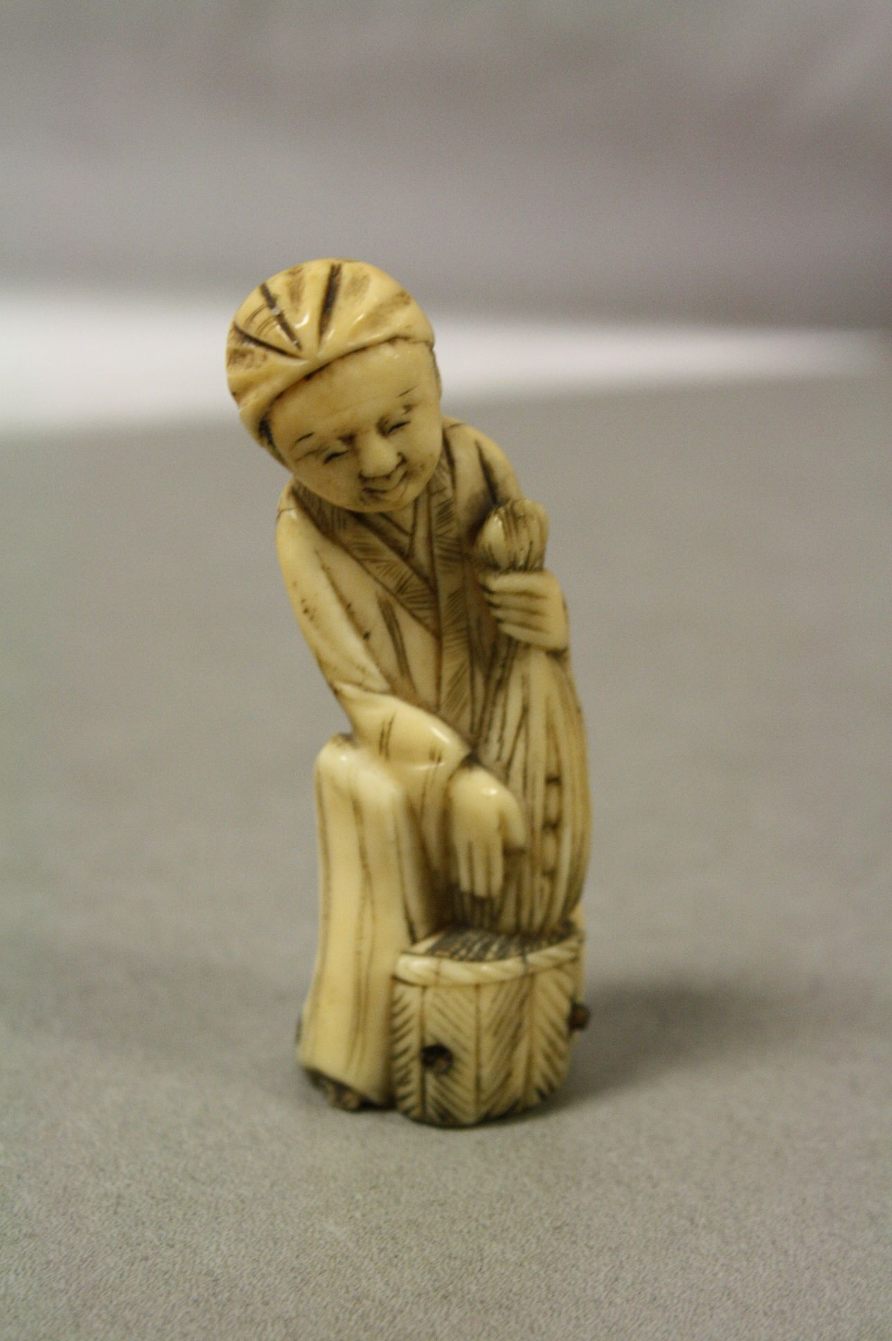 Antique ivory netsuke in the form of a man with net