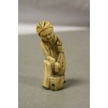 Antique ivory netsuke in the form of a man with net