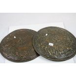 Pair of brass effect wall chargers decorated with medieval battle scenes