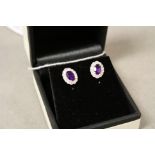 Pair of 18ct white gold amethyst and diamond cluster earrings