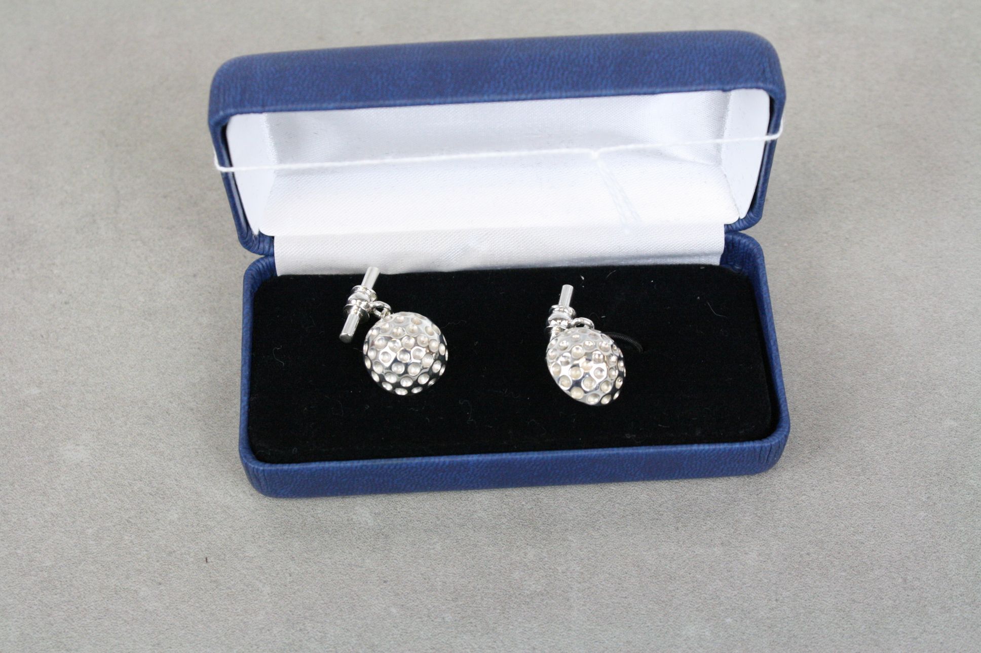 Pair of silver golf ball style cufflinks cased