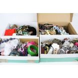 Four shoe boxes containing assorted costume jewellery