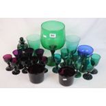 Quantity of green glass wine glasses and goblets, a collection of puce wine glasses, together with a