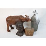 Carved wood buffalo figure, a similar African head, a soda syphon & a pair of binoculars