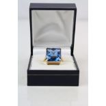 Blue topaz 18ct yellow gold ring, the rectangular mixed cut blue topaz measuring approximately