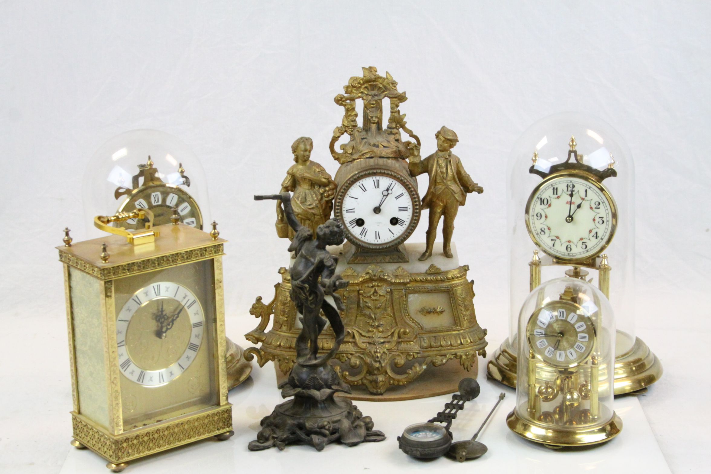 Three skeleton clocks, large quartz carriage clock, a mantle clock modelled as a dancing boy with