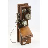 Early 20th century style telephone, mounted on wooden stand with paper label marked Centenary of the