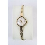 Ladies Hallmarked 9ct Gold Wristwatch with Rolled Gold strap, the silvered metallic dial marked "