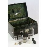 Crocodile skin covered travel case containing silver topped cut glass dressing table jars,