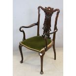 Early 20th century Mahogany Elbow Chair, the shaped splat pierced and carved including floral swags,