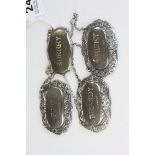 Three Hallmarked Silver decanter labels plus a white metal example