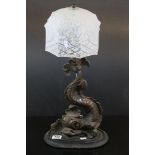 19th century doorstop in the form of a dolphin converted to a table lamp