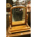 Victorian Satin Walnut Framed Swing Mirror raised on four flat bun feet, 60cms high x 58cms wide