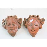 Pair of composite stone wall busts of young girls with flowers in their hair