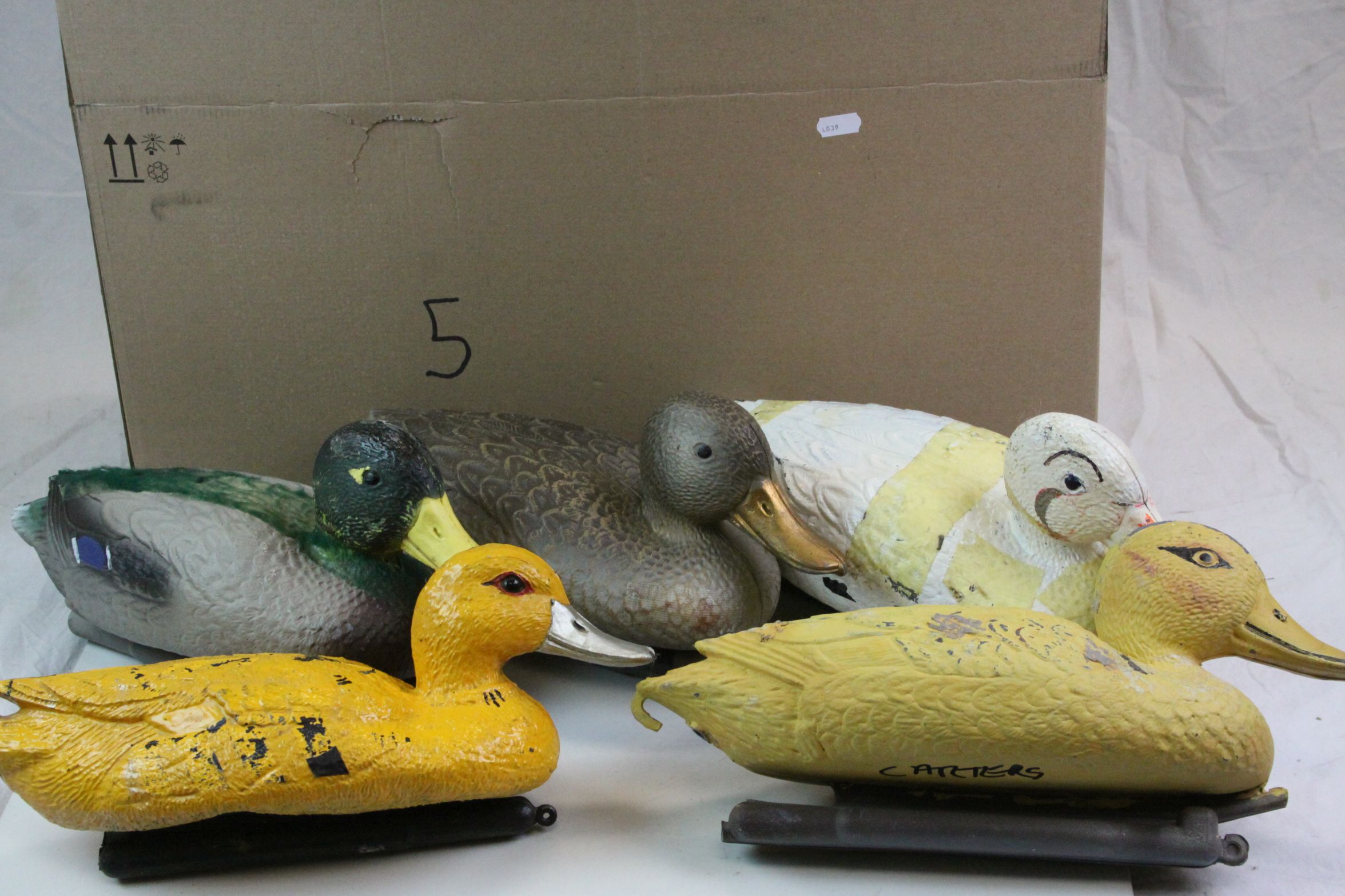 Seven plastic decoy ducks