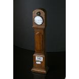Carved Oak Pocket watch stand modelled as a Longcase Clock fitted with Hallmarked Silver top wind