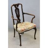 Early 20th century Elbow Chair with pierced carved splat, stuffed seat and raised on front