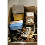 Box of assorted items to include a cased pair of binoculars, voltmeter, radio, vintage tins etc