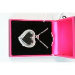 Cased silver heart shaped locket set with CZ's to the border
