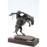 Franklin Mint Bronze effect model of Frederic Remington's "The Broncho Buster" with wooden stand,