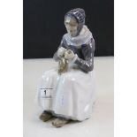 Royal Copenhagen figurine of a seated Female wearing Clogs and Sewing, numbered 1317 to base