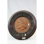 Teracotta Plaque portrait of a gentleman with indistinct inscription with heavily carved Oak