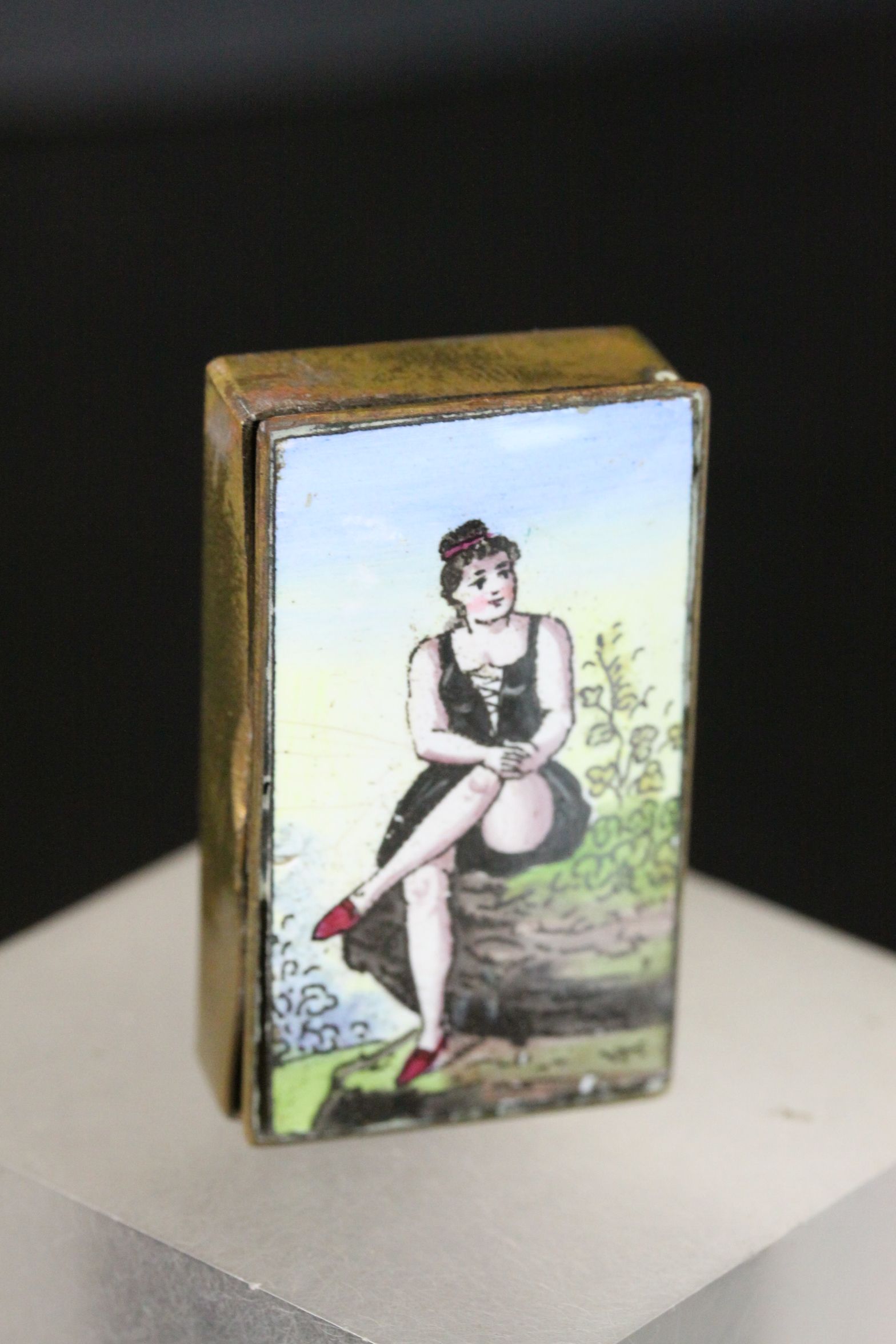 Edwardian Brass Vesta with hand painted Enamel scene to lid depicting a scantily dressed Female