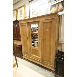 Continental Pine Triple Wardrobe with central mirrored panel flanked by two panel doors, one door