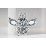 Silver bug brooch inset with opal panels and ruby eyes