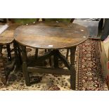 *18th century Oak Cricket Table, the circular top on three turned and square section legs joined