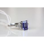 Tanzanite and diamond 18ct white gold ring, the central rectangular step cut tanzanite measuring